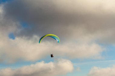 Yaz günü bulutlar üzerinde uçan Yamaçparaşütü