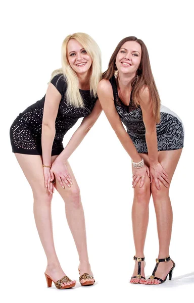 Studio fashion image of two beautiful young women in black and red dresses, isolated — Stock Photo, Image