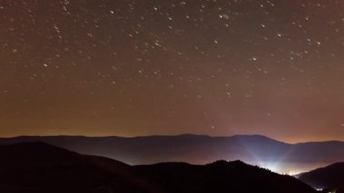 Stars over Synevyr pass in the Carpatian Mountains. Wonderful incredible night sky over Kamenka. A cinematic magical view of the universal space with millions of shining stars. Synevyr Pass