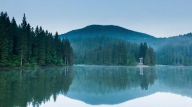 Güzel doğa ve bereketli yeşil ormanlar ve Karpatlar 'ın incisinin etrafındaki bitki örtüsüyle harika bir manzara - Synevyr Gölü. Ukrayna 'daki Karpatlar. Büyük fırtınaların üzerinde mistik bir sis var. Yüksek