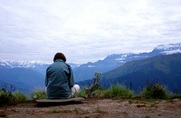 Women silhouette, meditaing over Annapurna mountain landscape