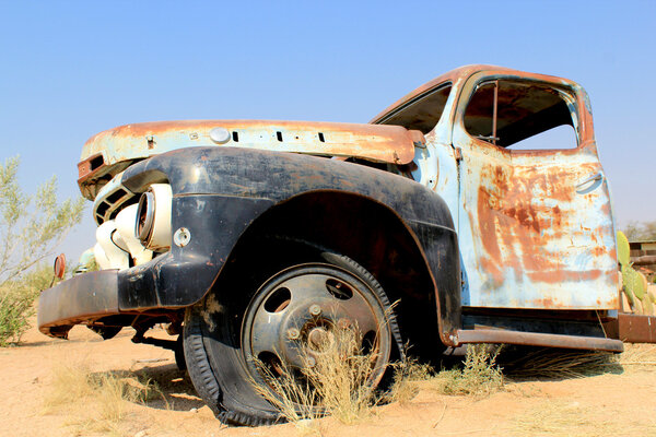 Old and rusty car wreck at the last gaz station before the Namib