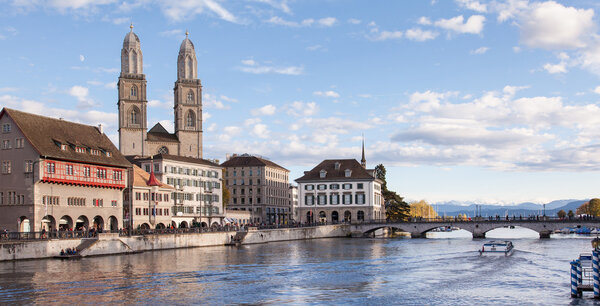 Zurich, Switzerland. The Limmat river, the Great Minster, early evening.