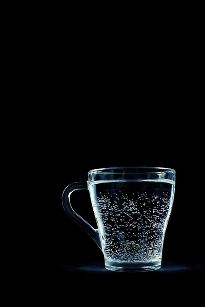 Glass of water with bubbles on black background — Stock Photo, Image