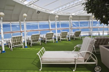 Sunbeds on sundeck of the cruise ship clipart