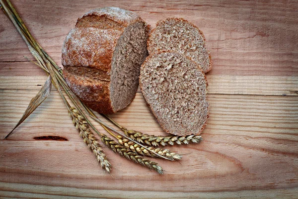 Fresh bread on a wooden table — Stock Photo, Image