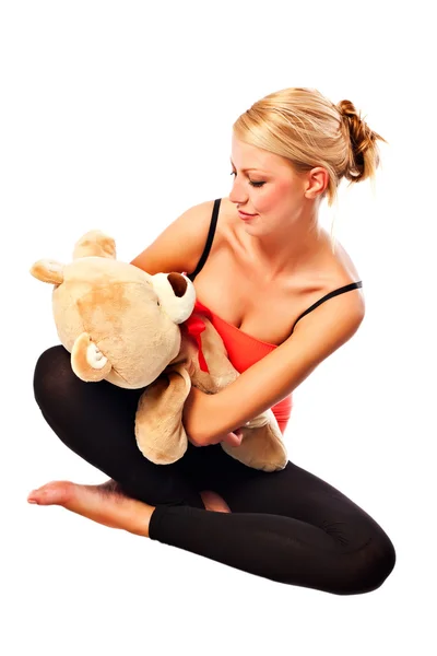 Beautiful young blonde girl with plush bear — Stock Photo, Image