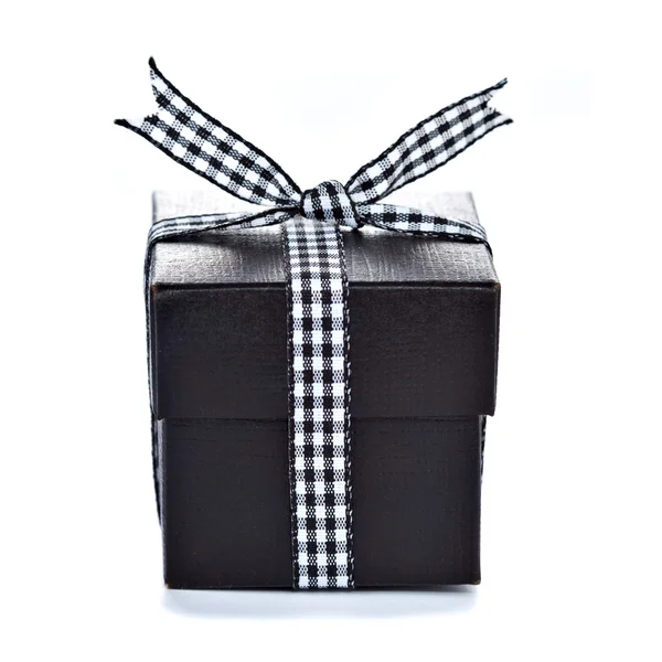Black gift box with checkered ribbon — Stock Photo, Image