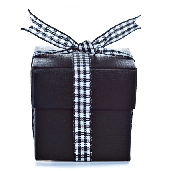 Black gift box with checkered ribbon — Stock Photo, Image