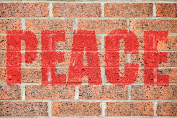 Old brick wall texture with PEACE inscription — Stock Photo, Image