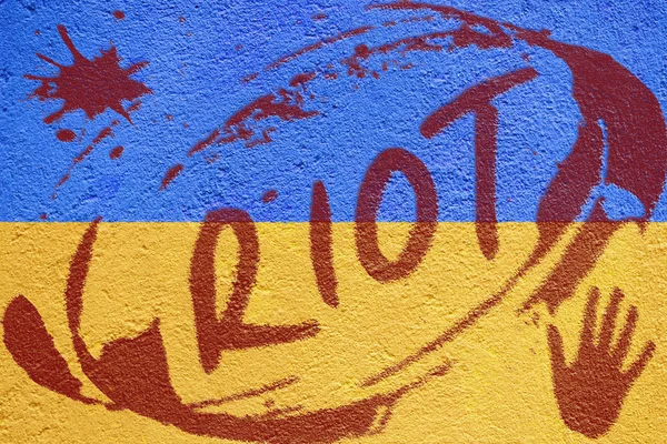 Ukraine flag painted on old concrete wall with RIOT inscription — Stock Photo, Image