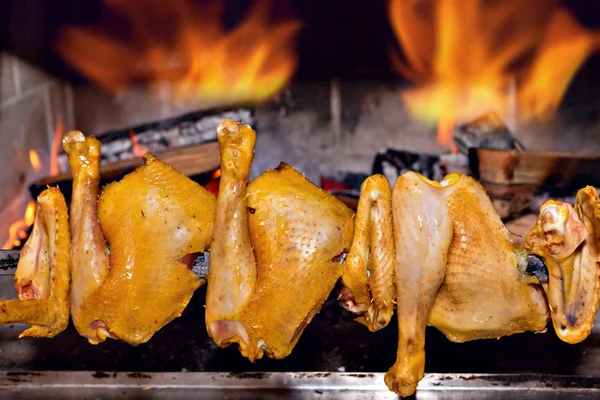 Chicken roasting on skewer — Stock Photo, Image