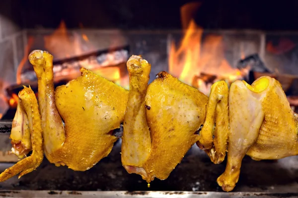 Chicken roasting on skewer — Stock Photo, Image