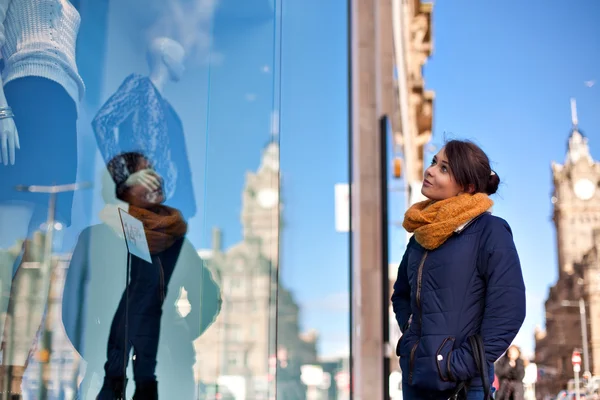 Девушка смотрит на витрину магазина — стоковое фото
