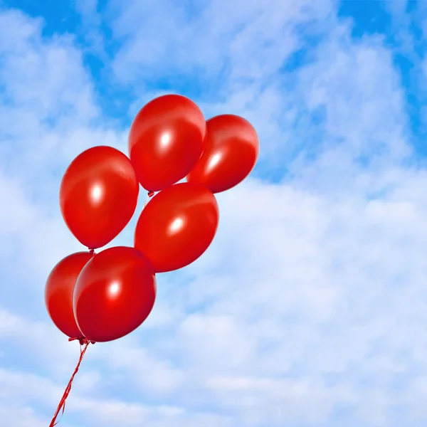 Red inflatable balloons on the sky background — Stock Photo, Image