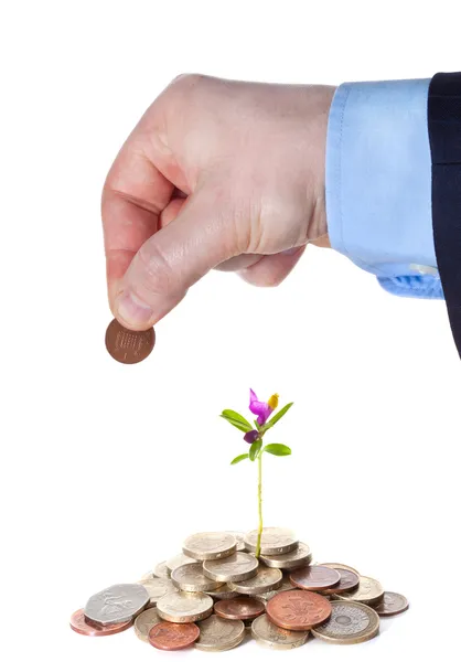 Hand puts a penny to a heap of British coins — Stock Photo, Image