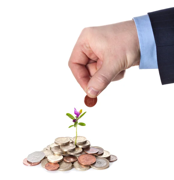 Hand puts a penny to a heap of British coins — Stock Photo, Image