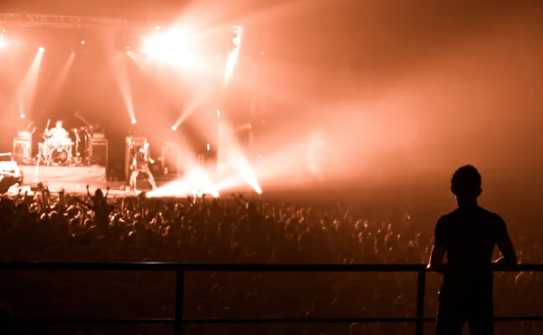 Silueta del hombre, viendo una explosión en el escenario — Foto de Stock