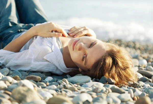 Piękna młoda kobieta, leżąc na plaży — Zdjęcie stockowe