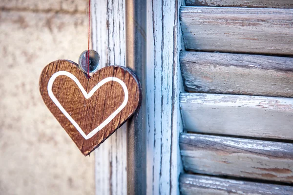 Drewniane serca na tle okiennicami w kolorze niebieskim — Zdjęcie stockowe