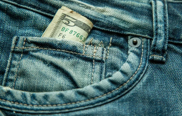 5 dollars in the pocket of jeans — Stock Photo, Image