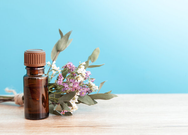 bottle of aroma oil and wild flowers