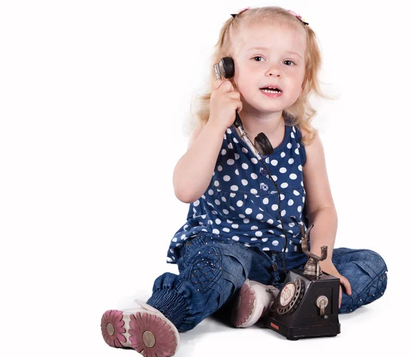 Curly-haired little girl with a vintage telephone — Stock Photo, Image