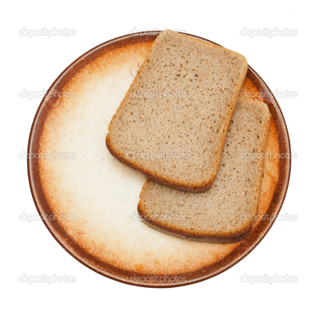 Two pieces of bread on a brown plate isolated ⬇ Stock Photo, Image by © OlezzoSimona 40164679