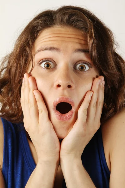 Portrait of a surprised young woman with curly hair — Stock Photo, Image