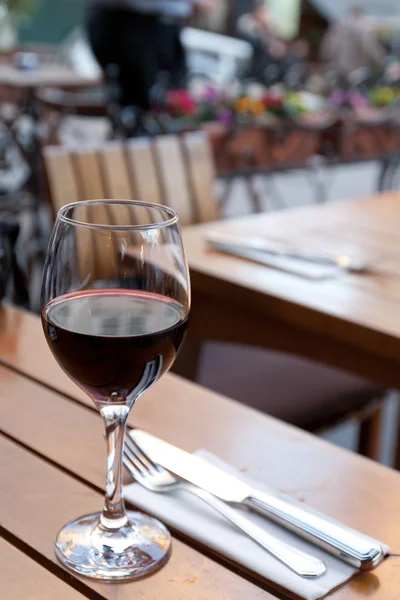 One glass of red wine on a table at cafe — Stock Photo, Image