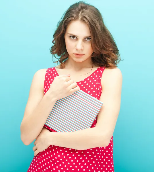 Beautiful girl in a red polka dot blouse with a diary — Stock Photo, Image