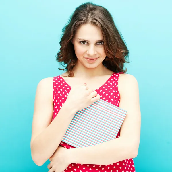 Beautiful girl in a red polka dot blouse with a diary — Stock Photo, Image