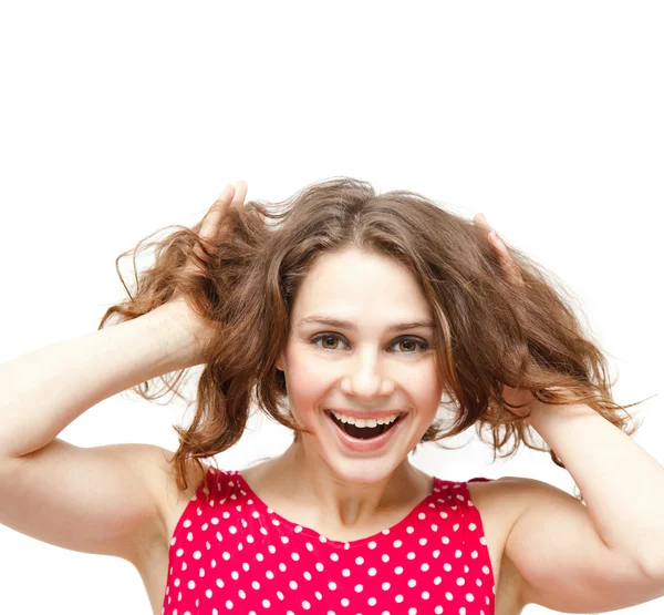 Young beautiful woman in red blouse holding his head, smiling, i Stock Image