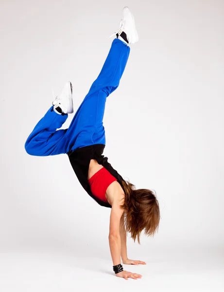 Beautiful young woman standing on hands — Stock Photo, Image