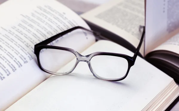 Verres et livres ouverts sur la table — Photo