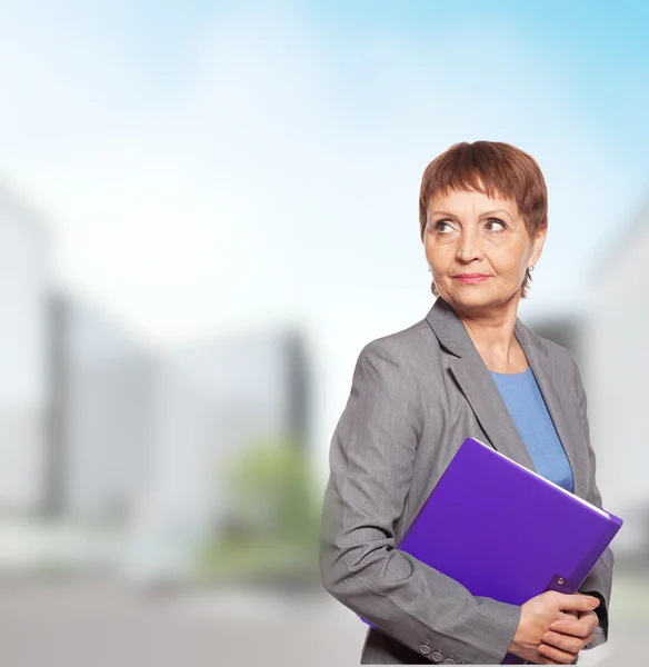 Attractive woman 50 years old with a folder for documents — Stock Photo, Image