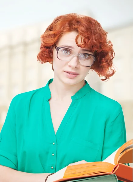 Fille aux cheveux roux en lunettes avec des livres — Photo