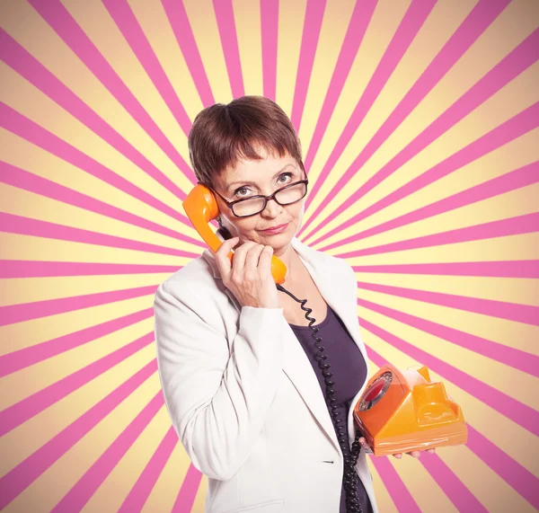 Attractive woman 50 years with vintage telephone — Stock Photo, Image