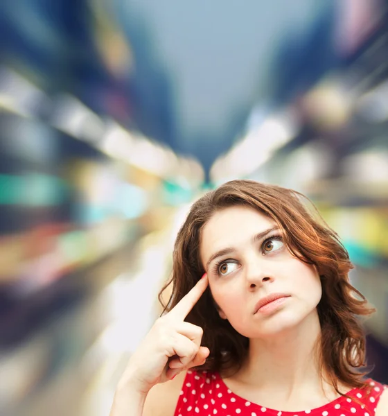 Young beautiful woman in red blouse thought — Stock Photo, Image