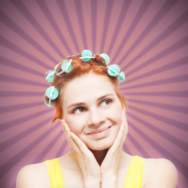 Funny portrait of redheaded girl in hair curlers on retro  backg — Stock Photo, Image