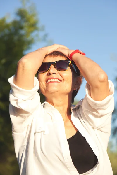 Attractive woman 50 years in sunglasses — Stock Photo, Image