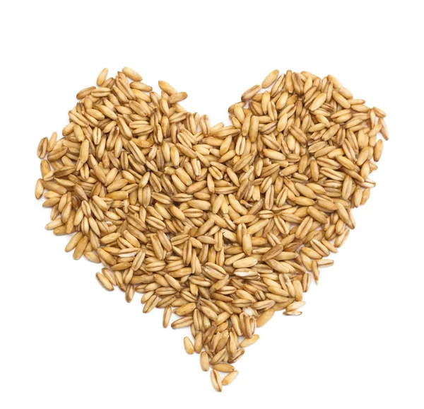 Natural oat grains in form of the heart, isolated on white Royalty Free Stock Photos