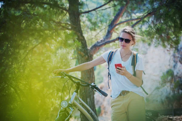 Young Woman Bicycle Smartphone Her Hands Bike Ride Forest — Stock Photo, Image