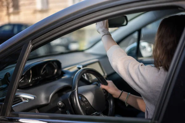 Woman Adjusting Rearview Mirror While Sitting Car Drivers Seat Ripping — Stockfoto