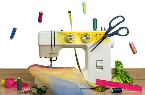 Sewing machine and thread, fabric on a white background Royalty Free Stock Images