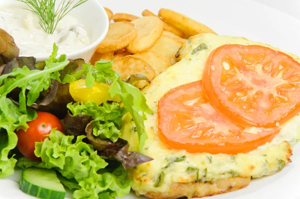 Meat in French with French fries and vegetables — Stock Photo, Image