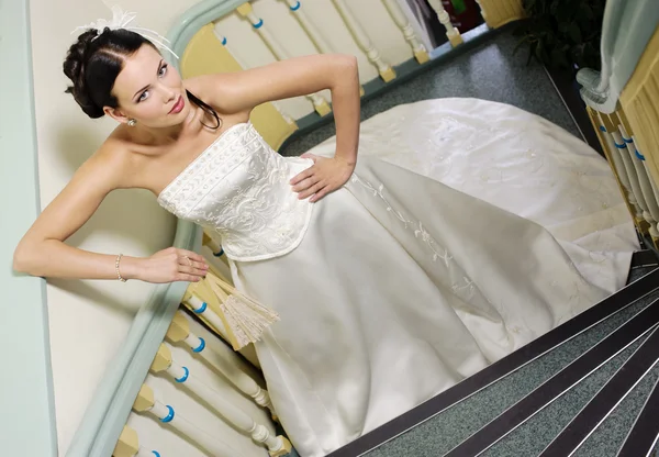 Beautiful bride posing on the stairs — Stock Photo, Image