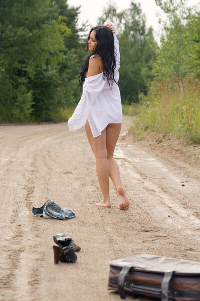 Girl white shirt walking along countryside road