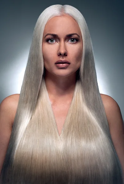 Portrait of a beautiful blonde with a long futuristic hair — Stock Photo, Image