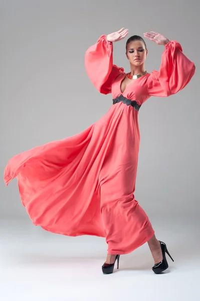 Girl in a long red dress dancing — Stock Photo, Image